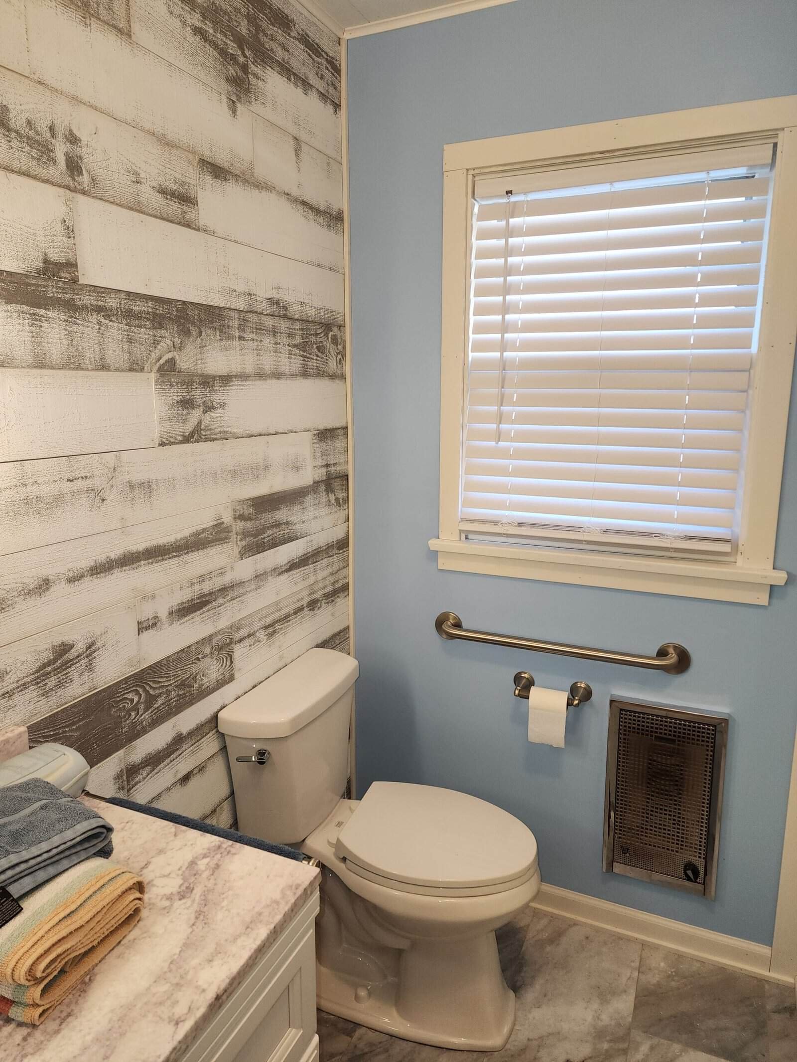 Bathroom with finished wall surfaces, vanity, window, and tiled details