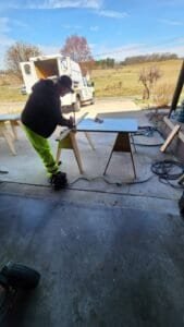 Worker shown during fabrication and installation work