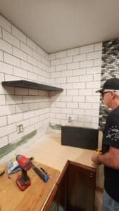 Worker shown during kitchen remodeling